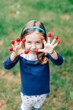 © Jakob Lagerstedt/Stocksy - Cute young girl with raspberries on her fingers