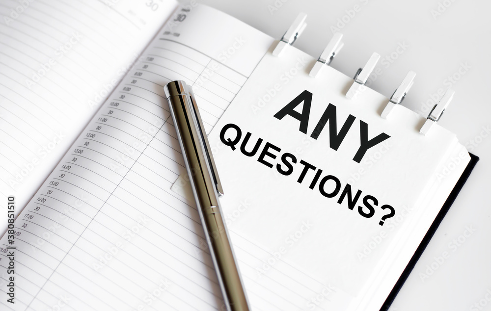 text ANY QUESTIONS on the short note texture background with pen Stock ...