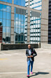 © Kristen Curette Photography LLC/Stocksy - An African American man walking in business attire outdoors in the city