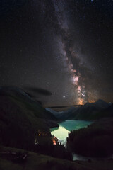 Wall Mural - night landscape with stars and the milky way. mountains and lake, starry sky, night. the vertical po