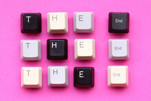 'The End' Written With Computer Keyboard Keys On A Paper Background