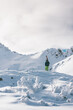 © Akela - from alp to alp/Stocksy - male skier standing in snowcovered alpine winter landscape