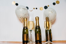 3 Bottles Of Champagne, Glasses With Drink And Party Decor