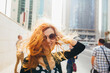 © Photography by Maja Topcagic/Stocksy - Redhead on the street with wind in her hair