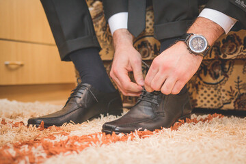 Wall Mural - Closeup shot of a male tying shoelaces