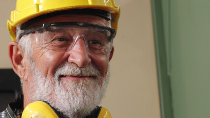 Wall Mural - Senior factory worker or engineer close up portrait in factory . Industry and engineering concept .