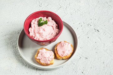 A bowl with tarama and crostini or taramasalata canape on the gray plate. Vegetarian appetizer