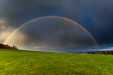 Fototapeta Tęcza - Dopple Rainbow, Thunderstorm is coming with rain, clouds are warm illuminated from the sun,on the horizont blue sky, Kulm, Thuringia, Germany
