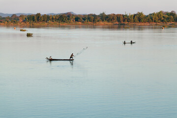 Muong Khong Laos 1/12/2012 Mekong river at sunset with and fishing boat and nets