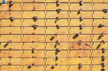 Wall Mural - Panel of metal intage grunge locked with padlocks post boxes closeup