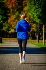 Wall Mural - Healthy lifestyle - woman running in city park
