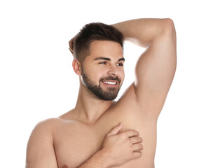 Wall Mural - Young man showing hairless armpit after epilation procedure on white background