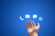 © Angkana - Call Center and Contact US Concept : Hand holding and showing contact us icon symbols in blue background.