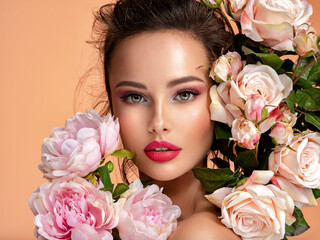Wall Mural - beautiful white girl with flowers. stunning brunette girl with big bouquet flowers of roses. closeup