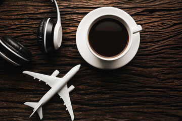 A cup of coffee with headphone on wooden table. Top view of coffee with copy space. Drink concept.