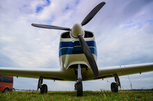 Small Single-engine Civil Airplane On A Green Grass Of A Countryside Airdrome