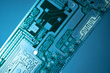 Poster - Microboard on a dark background. PCB board without processors and labels. Fragment of PCB board close-up. Background on theme of computer boards. Computer detail. PCB board without copper tracks