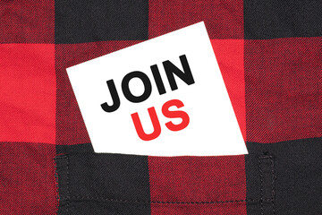 Poster - White business card with text JOIN US lies in the sleeve of a checkered shirt