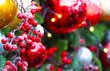 Christmas holiday decoration background, close-up. Festive beads, red berries, xmas tree balls toys on christmas tree, garland illumination