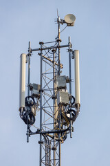 Poster - tower with antennas and transmitters against a blue sky