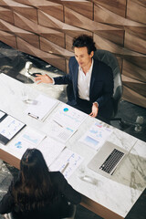 Canvas Print - Head of finance department discussing charts and diagrams with female manager at meeting