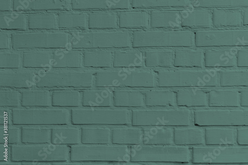 Old green stucco brick wall.