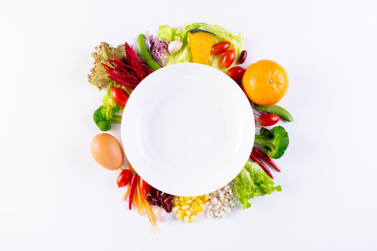 World food day, vegetarian day, Vegan day concept. Top view of fresh vegetables, fruit, with empty plate on white paper background.