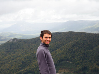 young man in the top of a mountain