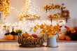 © sergiophoto - Autumn kitchen interior. Red and yellow leaves and flowers in the vase and pumpkin on light background