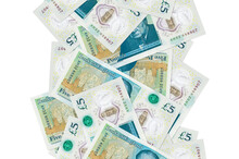 5 British Pounds Bills Flying Down Isolated On White. Many Banknotes Falling With White Copyspace On Left And Right Side