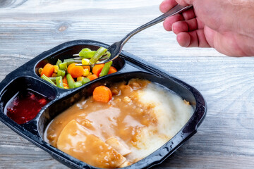 TV dinner and fork full of vegetables ready to eat