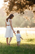 © Andriy Medvediuk - mother and son walking in the park on summer sunny day. mother's, baby's day. family concept