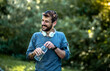 © Sanja - The young man pauses during training, rests, closes the bottle of water and smiles