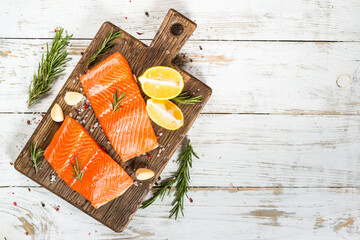 Wall Mural - Salmon fish with ingredients at white table.