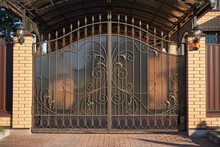 Forged Metal Gates With Ornate Lines To Enter A Private House