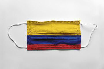 Wall Mural - Face mask with Colombia flag printed, on white background, isolated