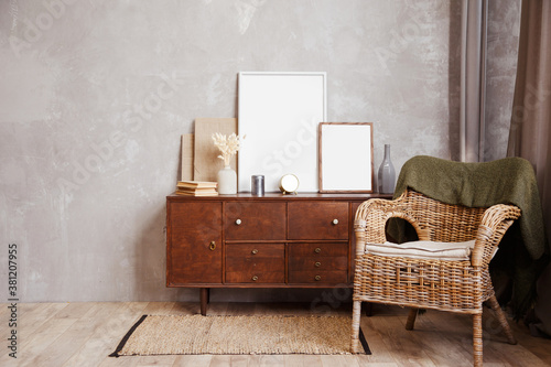 Cuadros en Lienzo Minimalistic composition of sitting room interior with wicker rattan armchair and wooden cabinet with white mock up frames and accessories on it