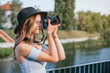 © Irving Sandoval - Young tourist woman using her professional camera and taking photos outdoors