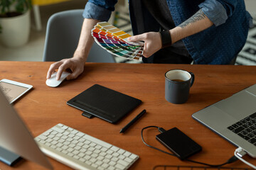 Wall Mural - Hands of creative software developer or web designer with color palette