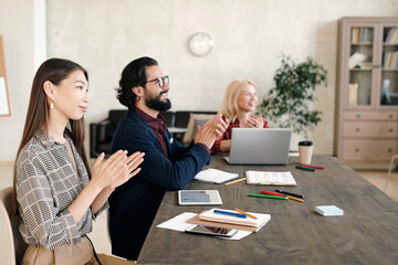 Poster - Three contemporary intercultural professionals clapping their hands after speech