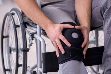 Young leg injured man in wheel-chair