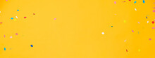 Colorful Confetti On Yellow Banner Background With Copy Space In The Middle