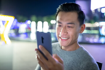 Canvas Print - asian man use phone outdoor