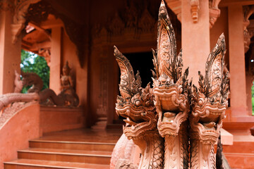 Wall Mural - Statue of the three head serpent in front of the temple entrance