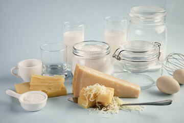 Poster - Shot of a delicious cheese platter with milk and eggs isolated on a light blue background