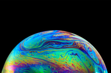 Wall Mural - macro picture of half soap bubble on black ground look like abstract psychedelic color planet in spa
