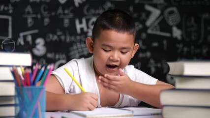 Wall Mural - The boy was sleepy and crouched on the table.