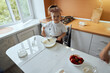 © Alexandr - Little girl makes dough on kitchen.