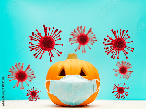 October and Autumn pumpkin.Halloween facial mask as a jack o lantern pumpkin wearing a medical face mask protection virus infection coronavirus covid-19.Happy halloween trick or treat.New normal.