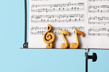 Sticker - Music sheets with notes on stand against color background